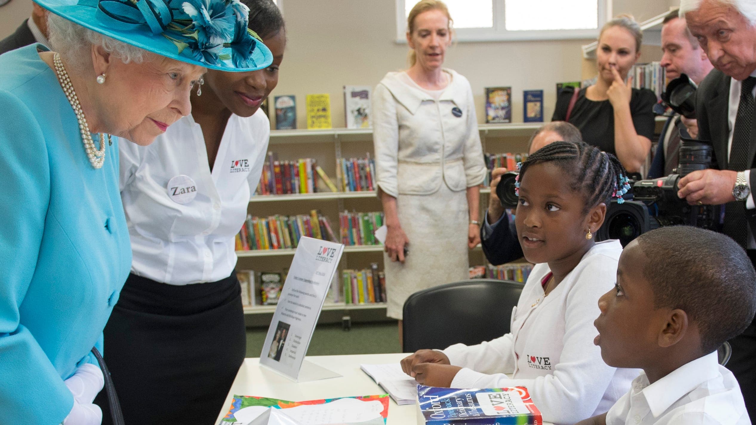 Queen Elizabeth II, accompanied by the Duke of Edinburgh (not in picture)talks to eight year old Nathan Dakoh during her visit to Chadwell Heath Community Centre where she met with local residents of all ages who use the facility.